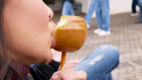 Close-Up-Woman-Eating-A-Candy---Toffee-Apple