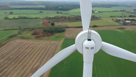 Close-panning-shot-behind-wind-turbine-in-British-countryside