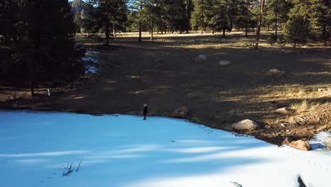 Girl-walking-on-frozen-white-lake-in-Colorado-mountains