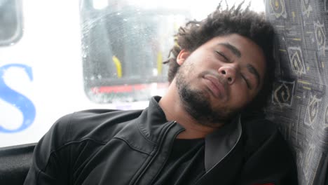 Young-African-American-Black-Man-Sleeps-on-Bus-Chair-Sitting-Down-Close-Up