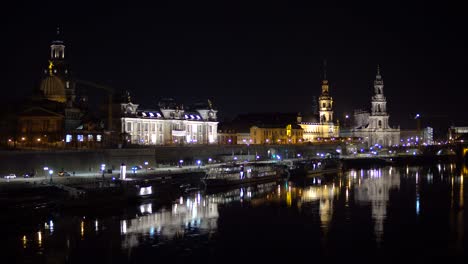 Dresden-city-skyline-at-night-with-reflections-on-river-Elbe,-Saxony