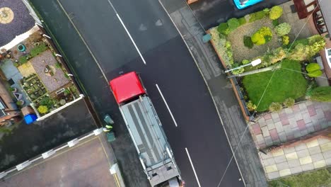 January-2019---Aerial-View,-footage-of-Dustmen-putting-recycling-waste-into-a-garbage-truck,-Bin-men,-refuse-collectors