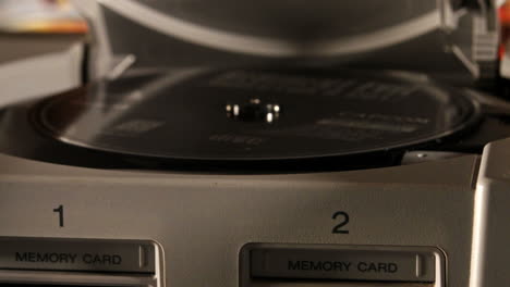 Opening-Vintage-Playstation-and-Placing-Disc-inside-SLIDE-LEFT
