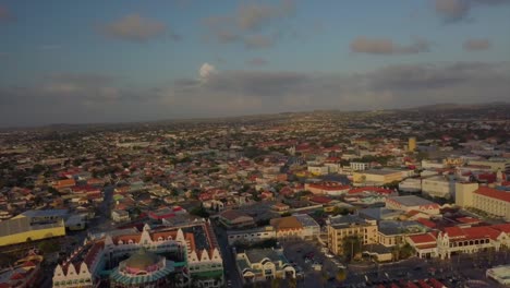 Aerial-pedestal-view-of-the-beautiful-marina-and-city-Oranjestad-of-Aruba-with-cars-driving-on-the-roads