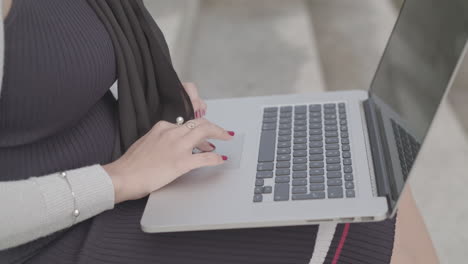 Close-Up-Shot-Of-A-Woman-Typing-On-A-Laptop-Outside-In-Slowmotion---Ungraded