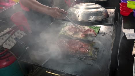 Close-up-of-seafood-being-prepared-on-griddle-at-a-Johor-food-stall