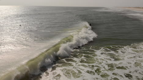 Epic-drone-tracking-shot-of-surfer-riding-a-wave