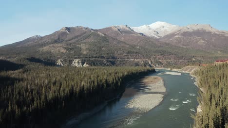 Drone-flies-sway-from-snowcapped-Alaskan-mountains