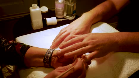 Close-up-of-a-man's-large-hands-getting-a-manicure