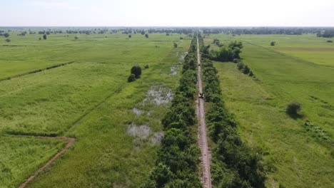 Bamboo-Railway-in-Battambang-Cambodia-with-Tourists-Aboard-Aerial-View