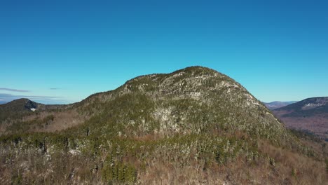 Aerial-slide-to-right-across-a-mountain-in-Maine-after-late-fall-snow