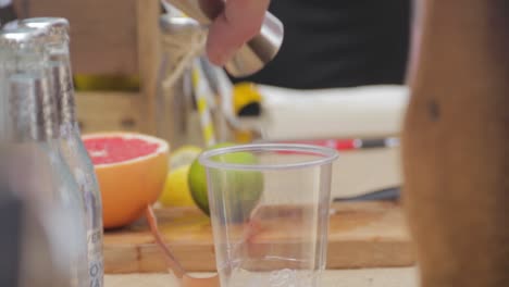 Shot-of-Gin-Poured-From-Measure-Into-Cup-of-Ice