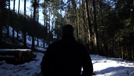 Young-man-walks-in-the-snowy-woods