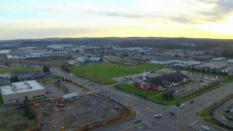 Drone-aerial-view-of-Kitchener-suburbs-with-construction-site-and-church-at-sunset