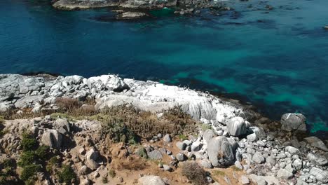 Aerial-footage-showing-clear-waters-and-rocky-formations-in-Cachagua,-Chile