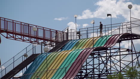 Kids-on-vacation-going-down-big-slide-in-tourist-town