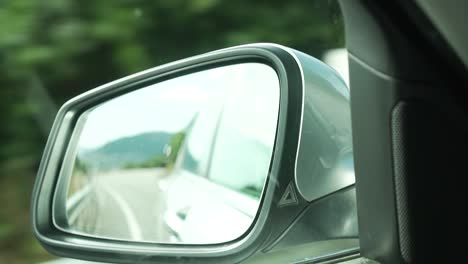 SLOWMO---Road-and-mountains-around-Queenstown-in-rear-mirror-of-luxury-car-bmw-730d