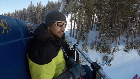 Man-on-a-ski-lift-wavin-on-the-camera