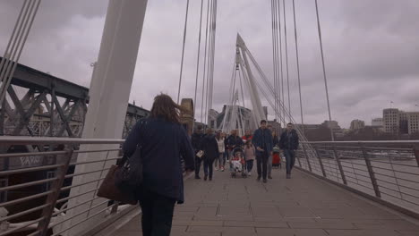 Walking-over-the-Jubilee-bridge,-London
