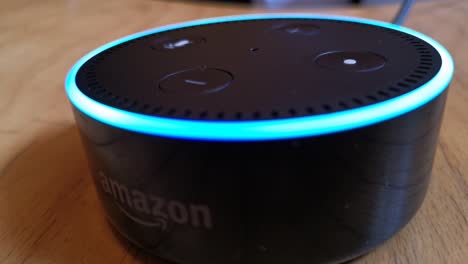 Close-up-shot-of-Alexa-Echo-Dot-device-answering-to-a-question