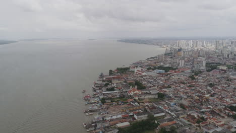 Aerial-shot-of-Belem-city-meeting-river,-pan-movement,-Brazil