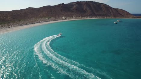 Aerial-shot-of-a-inflatable-towable-pull-by-a-small-boat-in-the-Sea-of-Cortez