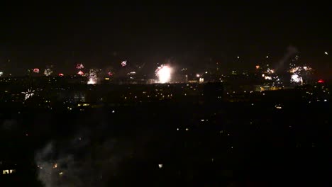 Massive-amountf-of-Fireworks-going-off-over-city-skyline-at-midnight-during-new-year