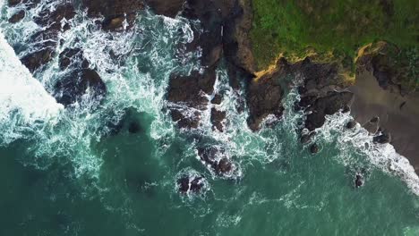 Ocean-waves-crash-against-rocky-California-cliffs