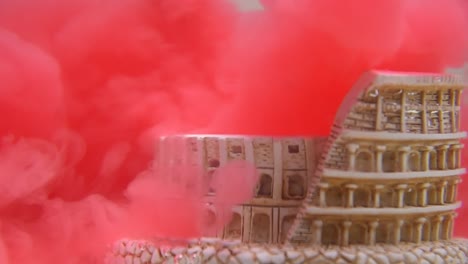 slow-motion-and-close-up-of-colosseum-underwater-with-red-water-ink-swirling-around-it
