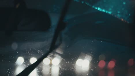 Artsy-slow-motion-shot-of-windshield-wipers-on-a-rainy-night