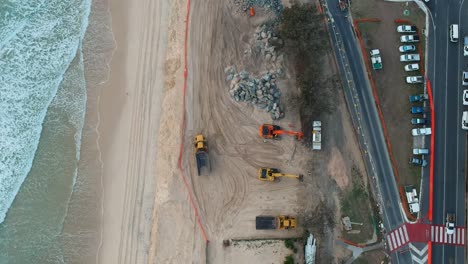 Large-construction-machinery-used-to-repair-beach-sand-dunes-damaged-by-recent-swell-from-a-tropical-cyclone