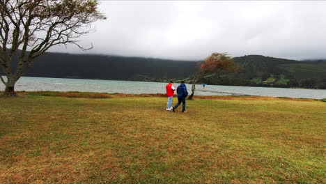 Two-men-walk-by-the-lake-of-Cete-Citades-on-the-island-of-Sao-Miguel-of-the-Portuguese-Azores