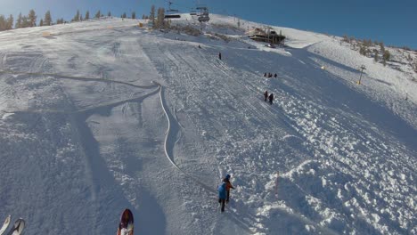 Men-in-groups-working-on-a-ski-resort-preparing-ski-slope-under-a-skilift