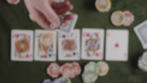A-person-flip-up-with-his-hands-one-"100"-value-token-into-the-air