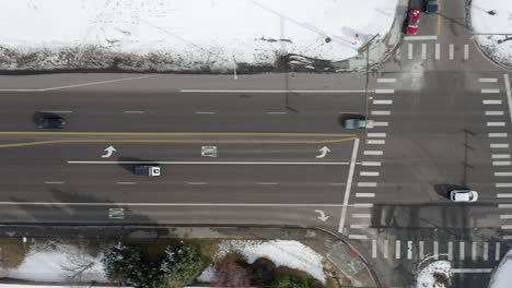Aerial-view-follows-cars-on-snow-day