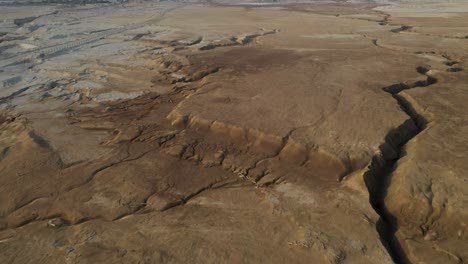 Desert-brown-stone-huge-crack-in-the-ground,-drone-shot