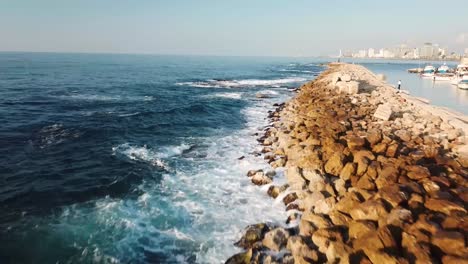 Beautiful-and-mesmerizing-clip-of-waves-and-white-foam-washing-over-the-rocky-breakwater-of-Jaffa-harbor