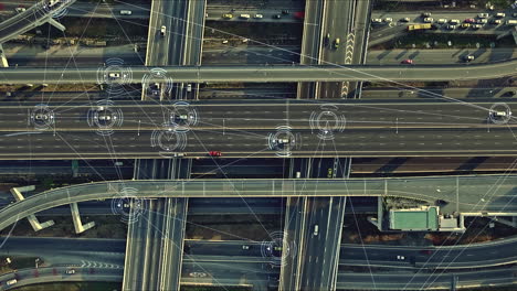 Aerial-view-from-above-of-traffic-on-the-elevated-expressway-with-futuristic-autonomous,-driverless-cars-using-artificial-intelligence-computer-network-and-satellite-gps-for-navigation