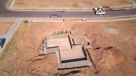 A-drone-shot-slow-pull-away-from-a-foundations-and-basement-walls-that-had-just-been-poured