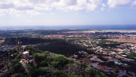 Aerial-view-of-cars-driving-on-South-end-of-Aruba-from-the-top-of-Hooiberg-mountain