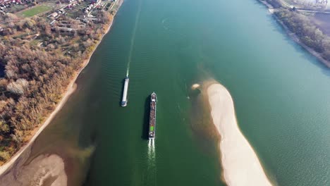 Aerial-view-of-a-transport-cargo-industrial-ship-on-a-river-in-europe