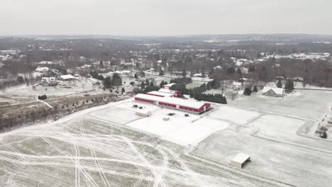 Winter-aerial-of-red-barn-in-Wisconsin