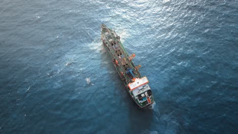 Aerial-view-of-a-large-container-ship-in-the-blue-ocean