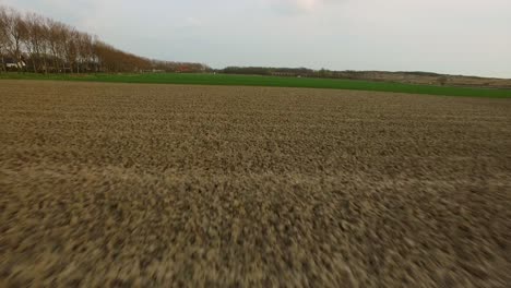 Aerial:-Fast-flying-shot-over-a-Dutch-landscape,-agriculture-area
