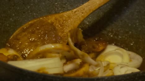 Closeup-of-stirring-Onions-in-Chilli-Prawns-Cooking