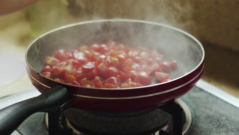 Spray-olive-oil-on-pan-to-fry-tomatoes