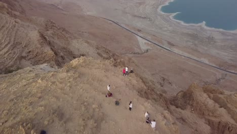 Tourist-standing-at-the-edge-of-the-cliff-to-view-the-Dead-sea-in-the-Middle-East