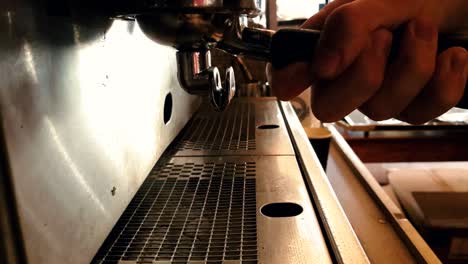 Close-up-view-of-chrome-espresso-machine-pouring-steaming-hot-double-shot-coffee-into-glass-cups