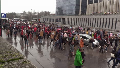 thousands-of-people-marching-peacefully-on-a-rainy,-cloudy-day-for-global-warming