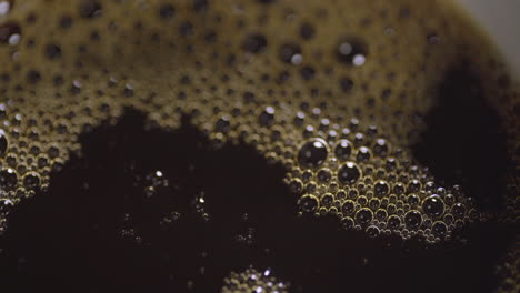 Close-up-macro-of-coffee-bubbles-as-mug-is-filled-up